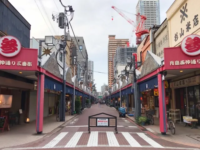 The flat, car-free Nishinaka-dori shopping street — Monja Street — in Tsukishima, Tokyo